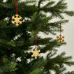 Brass snowflake ornaments set of 3 on tree