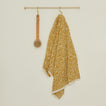 Medium brass towel bar with mustard space dye towel and brush