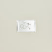 Overhead view of rectangular silver tray with a pair of hoop earrings and a pearl necklace inside.