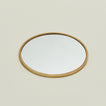 Detailed view of round brass mirror