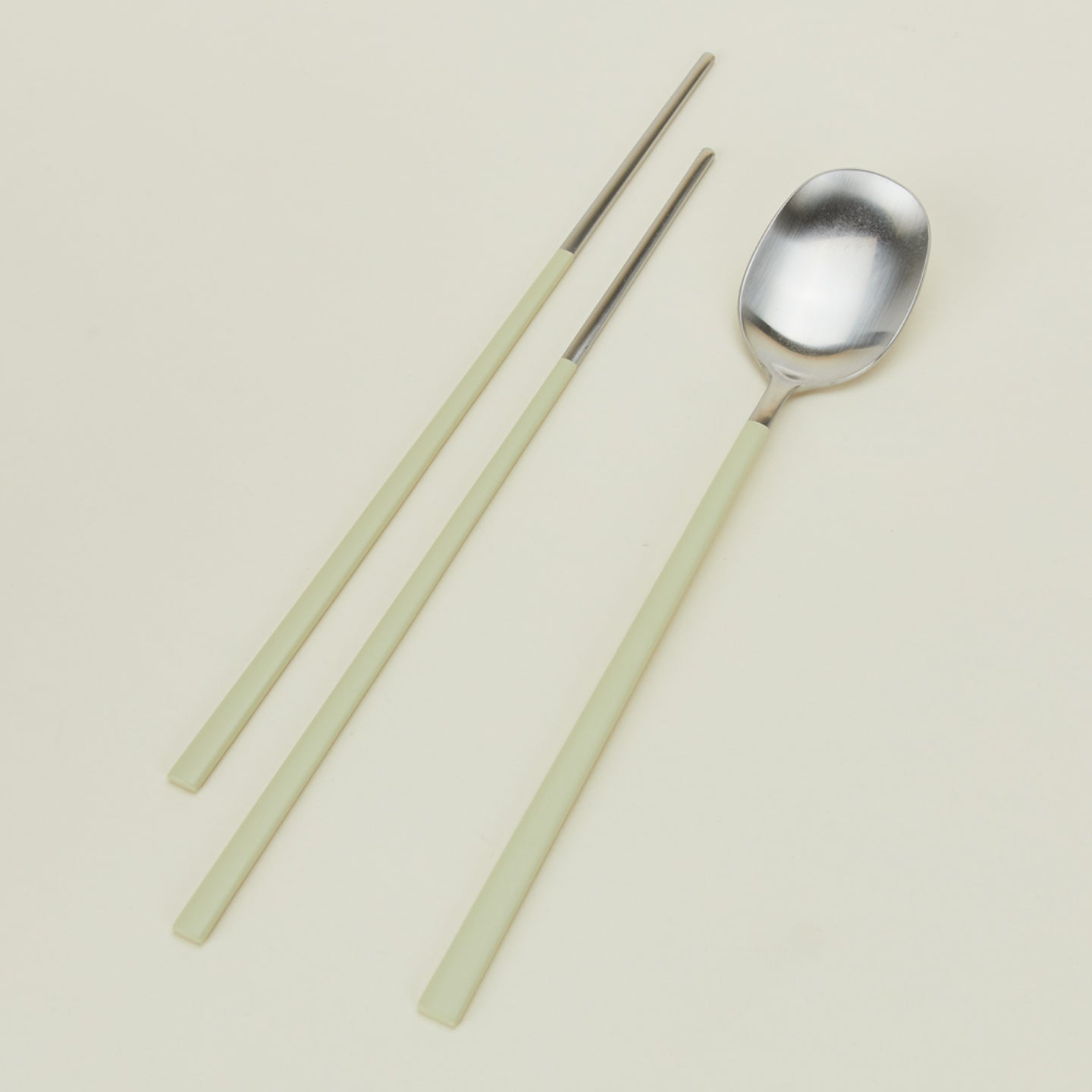Close up view of Illo spoon and chopstick set in mint