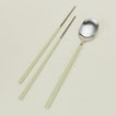 Close up view of Illo spoon and chopstick set in mint