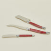 Close up view of Jean Dubost cheese knives in red