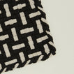 Detail view of parquet potholder in black and flax
