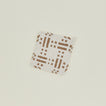 Dots and dashes potholder in white and flax