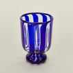 Close up view of blue striped wine glass