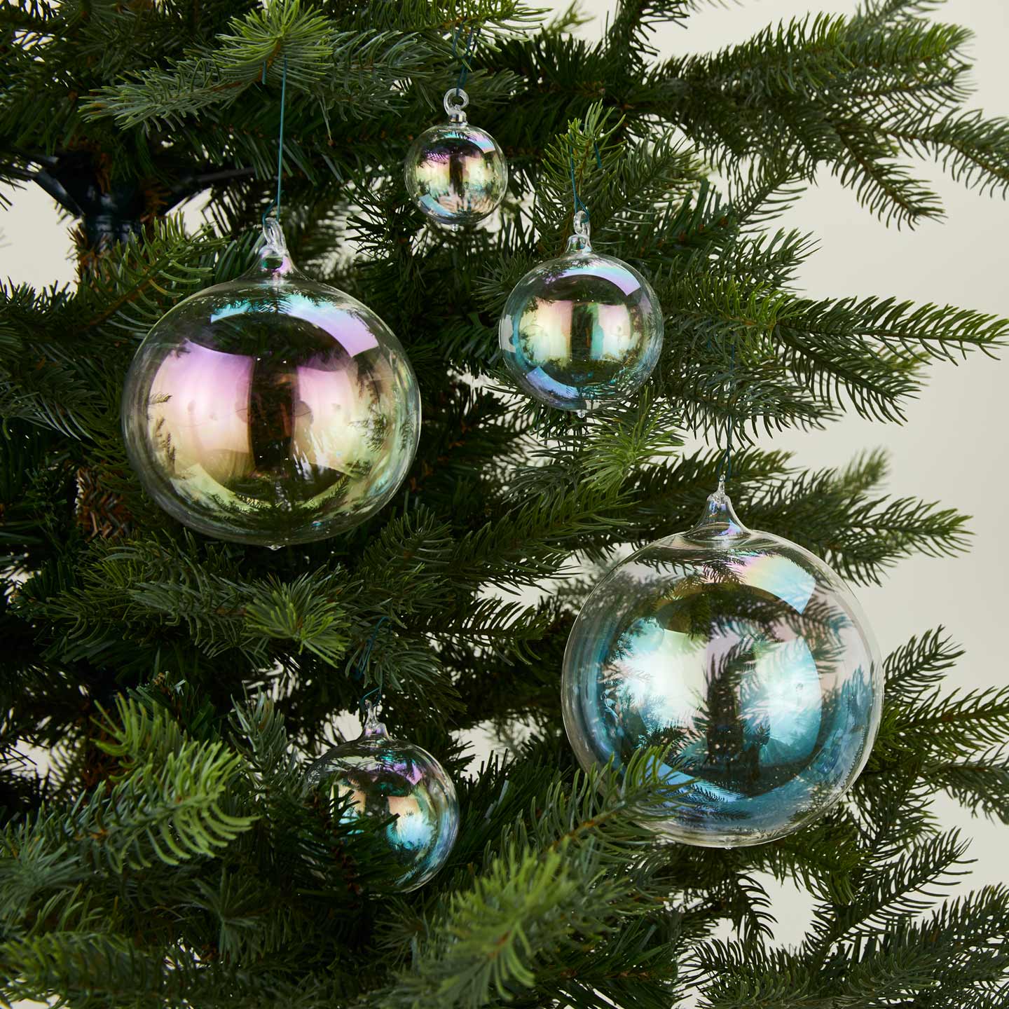 Iridescent ornament family on tree