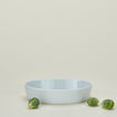 Medium porcelain deep oval baker in white with brussels sprouts