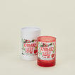 Candle with 'Tomato Leaf' design and white cylindrical container on a beige background