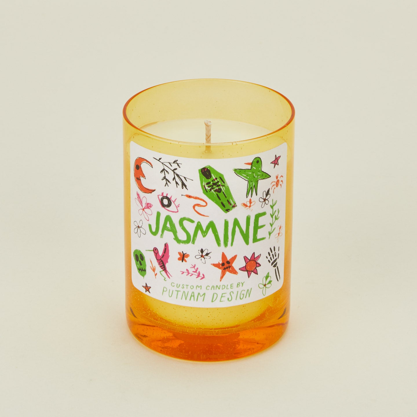 Candle with a colorful label on a beige background