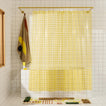 Sun grid shower curtain in butter in bathroom