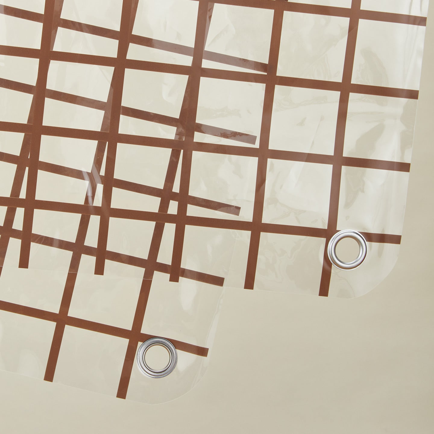 Close up view of sun grid shower curtain in honey