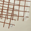 Close up view of sun grid shower curtain in honey