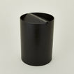 Lidded wooden waste basket in dark