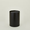 Lidded wooden waste basket in dark