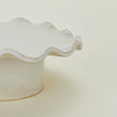Close up view of ruffle edge pedestal