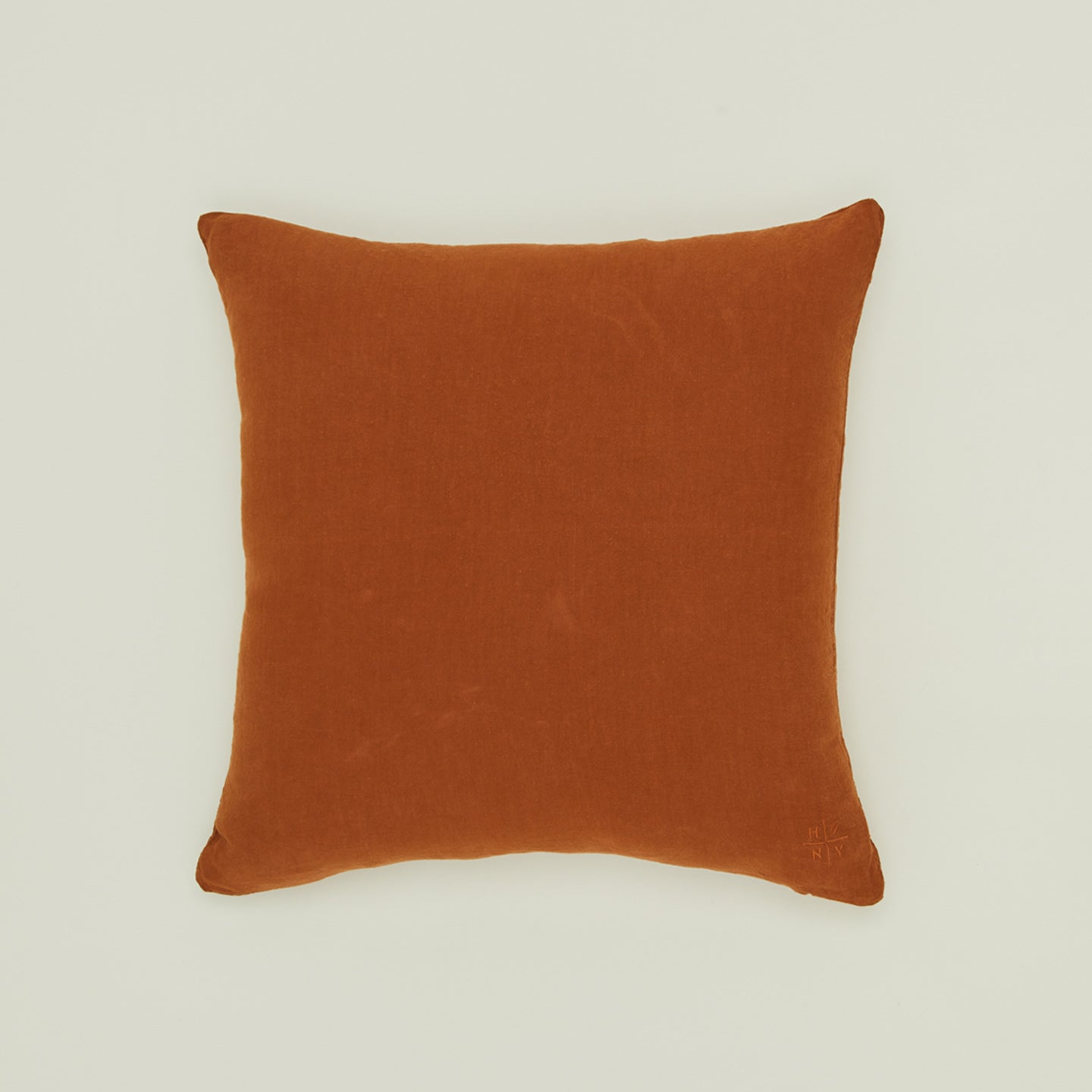 Simple linen pillow in terracotta