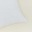 Close up view of simple linen pillow in white