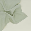 Detailed view of simple linen napkin in sage