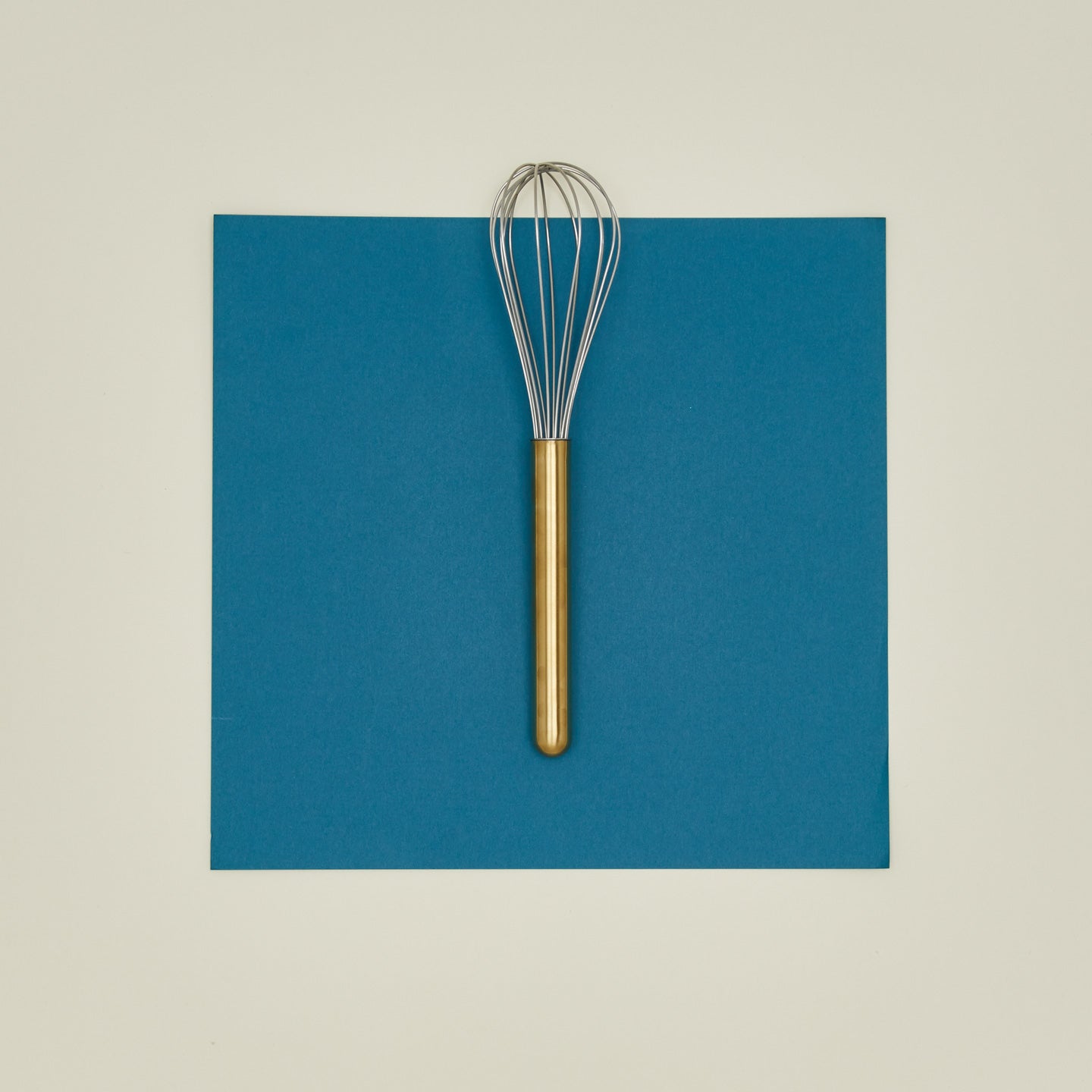 Simple metal whisk in brass