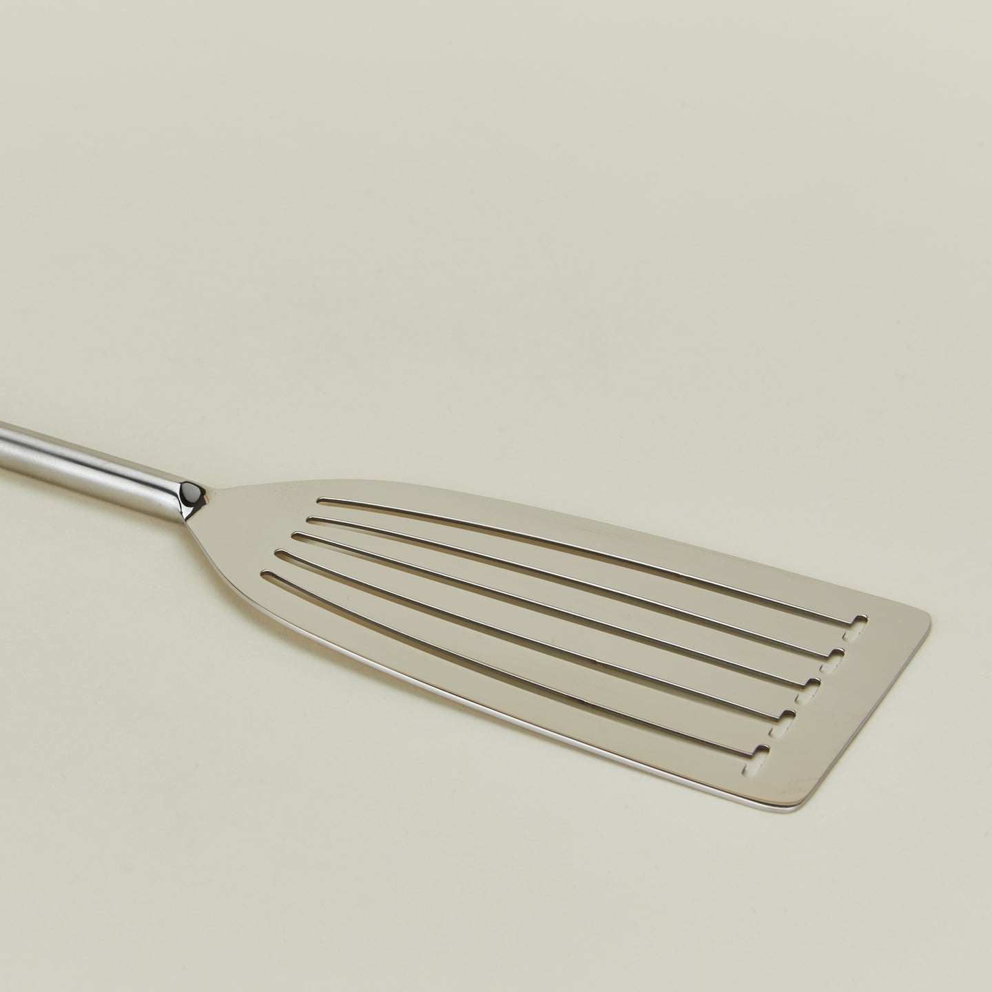 Close up view of simple metal fish spatula in silver