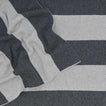 Striped throw in light grey and dark grey close up 