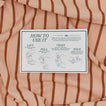 Striped towel with a label on top displaying 'How to Use It' instructions.