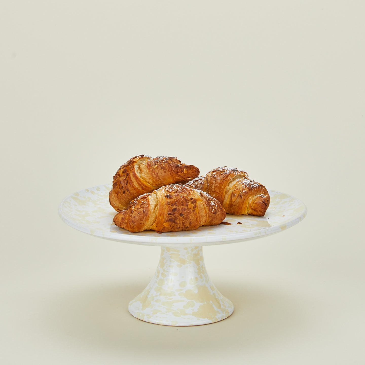 Splatterware cake stand in white and ivory with croissants