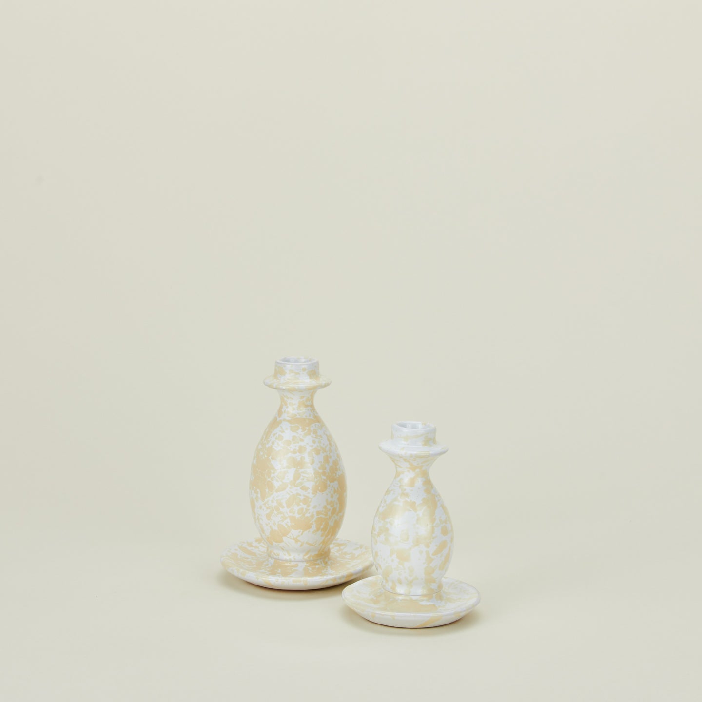 Splatterware candlestick holders in ivory and white