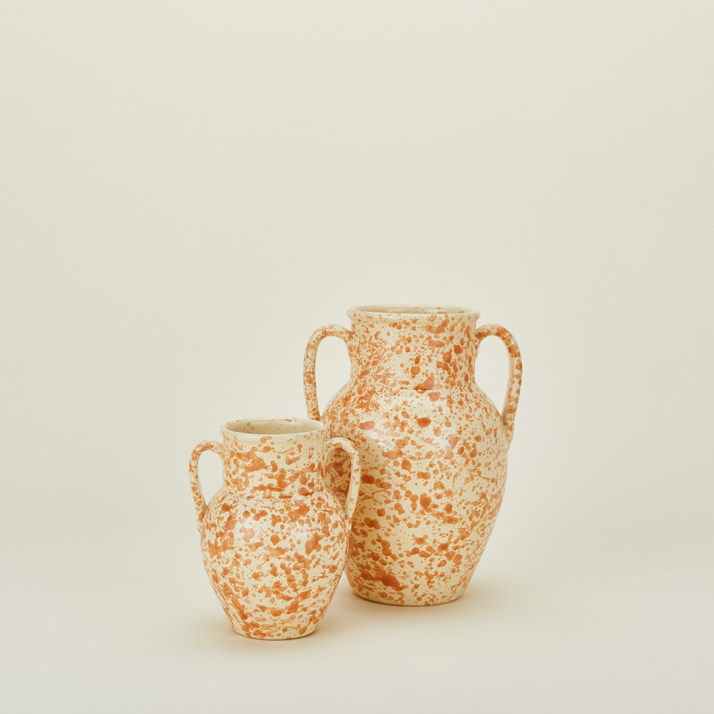 Large and small splatterware vases in ivory and bronze