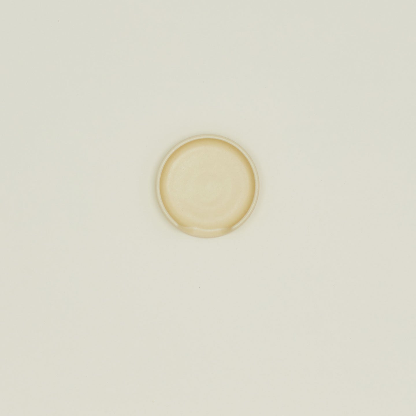 An overhead of a butter stoneware spoon rest.