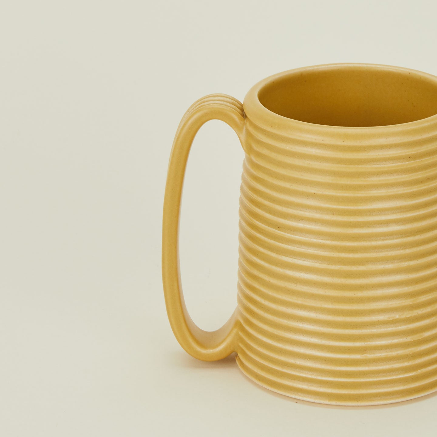 Close up of a Tall Ribbed Mug in Marigold.