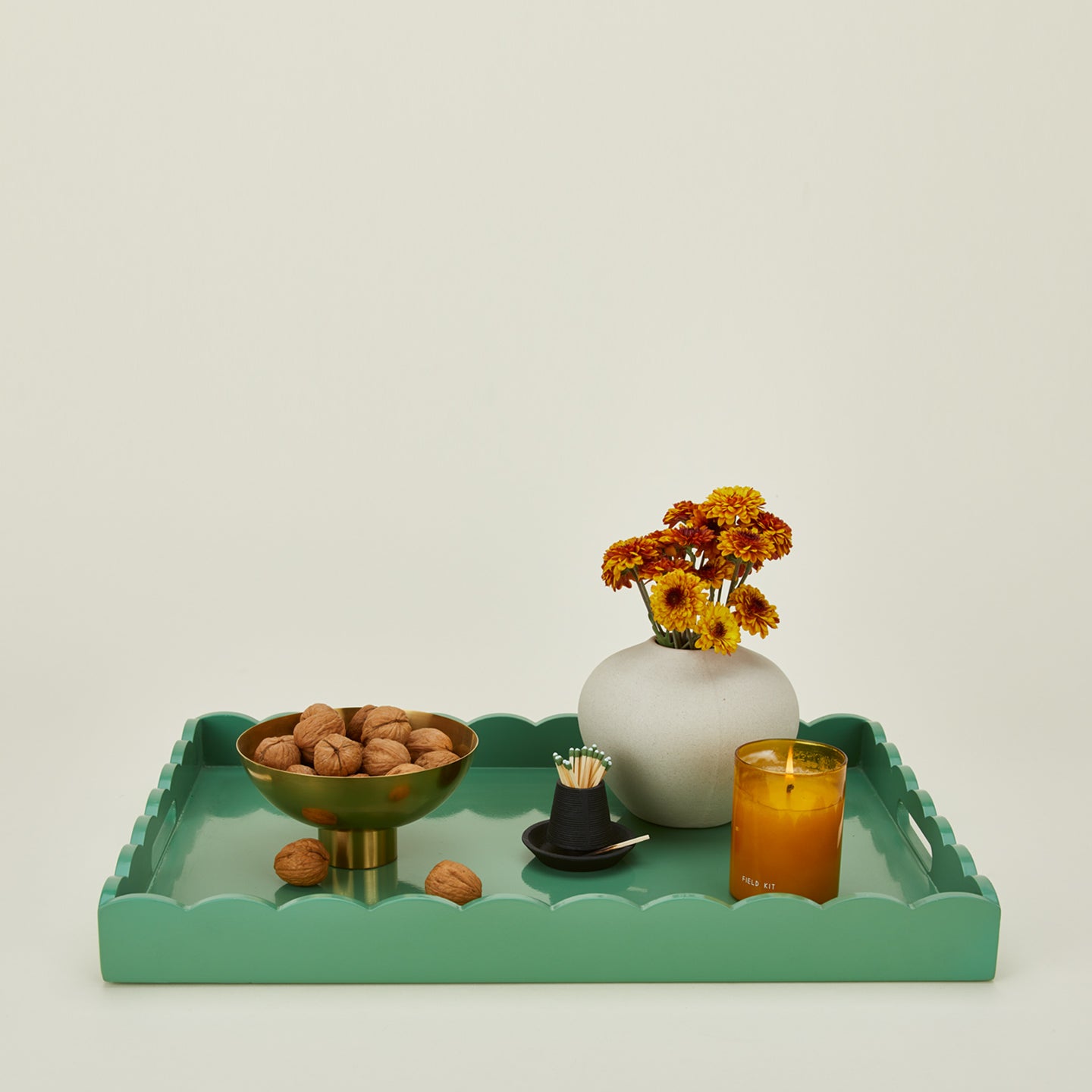 Moss serving tray with flowers, walnuts and candle