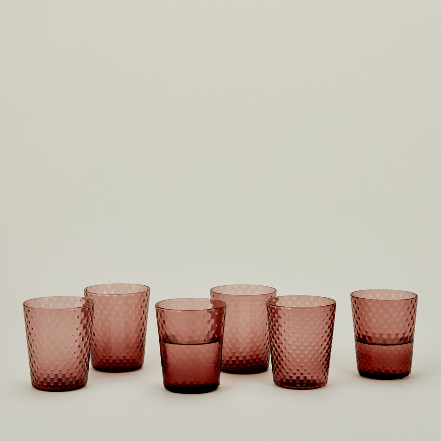 Set of 6 Veneziano Tumblers in Amethyst, with water.
