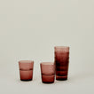 Set of 6 Veneziano Tumblers in Amethyst, stacked, with water.