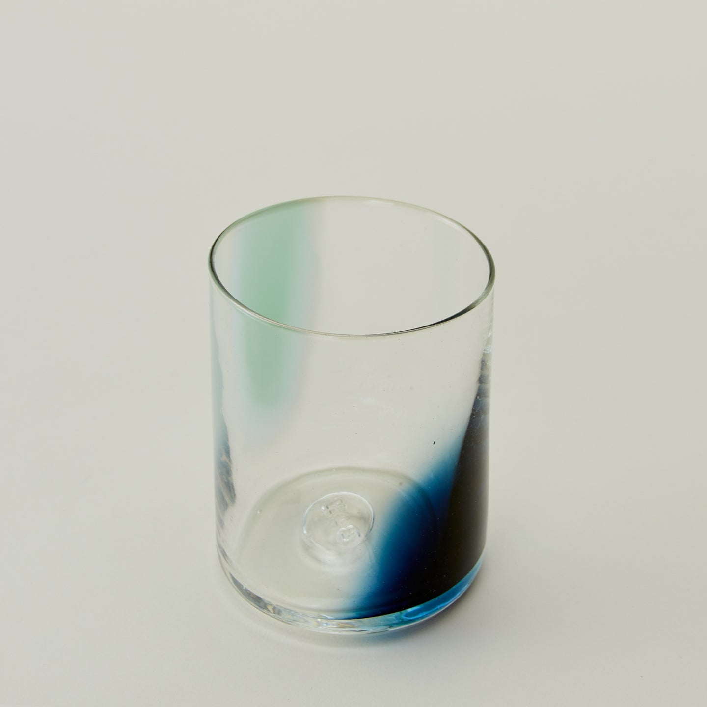 Close up of Blown Glass Tumbler in Sky and Peacock.